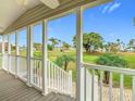 Picturesque view from the porch overlooking a beautifully landscaped green space with palm trees and vibrant scenery at 9000 Us Highway 192 # 896, Clermont, FL 34714