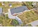 Birds eye view of a brick home with manicured lawn and long modern driveway at 1020 Hobson St, Longwood, FL 32750