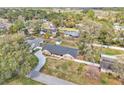 Sprawling aerial view of a brick home with a long driveway surrounded by lush greenery at 1020 Hobson St, Longwood, FL 32750