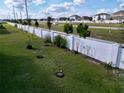 Spacious backyard with a pristine white fence and landscaping potential at 1042 Heirloom Dr, Haines City, FL 33844