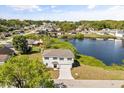 Aerial view of a two-story home next to a lake in a neighborhood at 1062 Hidden Dr, Lakeland, FL 33809