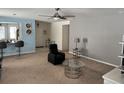Spacious living area with blue accent wall, ceiling fan, and a seamless flow into other parts of the home at 112 Lake Tracy Ct, Haines City, FL 33844