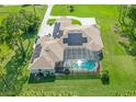 Aerial view of the home, showcasing solar panels and a screened-in pool area at 12177 Gray Birch Cir, Orlando, FL 32832