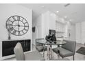 Bright dining area with modern furniture and a sleek design, open to kitchen at 12177 Gray Birch Cir, Orlando, FL 32832