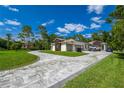 Wide driveway leading to a three-car garage and a well-maintained lawn at 12177 Gray Birch Cir, Orlando, FL 32832