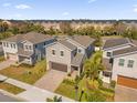 An aerial view shows the property has a brick paver driveway and lush landscaping in a vibrant neighborhood at 1252 Ash Tree Cv, Casselberry, FL 32707