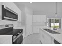 This modern kitchen features white cabinets, quartz countertops, and stainless steel appliances at 1252 Ash Tree Cv, Casselberry, FL 32707