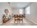 Bright dining room with a wooden table, four chairs, modern decor, and natural light at 1860 Tohoqua Blvd, Kissimmee, FL 34744