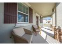 Inviting front porch with two comfortable wicker chairs, offering a relaxing outdoor space at 1860 Tohoqua Blvd, Kissimmee, FL 34744