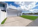 Spacious two-car garage with a long driveway and picturesque water view at 2022 Island Walk Dr, Orlando, FL 32824