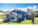 Cozy blue home featuring a welcoming front porch and vibrant green lawn at 205 9Th St, St Cloud, FL 34769