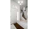 Bright foyer with tile flooring, staircase, and a view into other living spaces at 240 Minniehaha Cir, Haines City, FL 33844