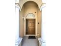 Elegant front entrance featuring stately columns and a paneled door with transom window at 240 Minniehaha Cir, Haines City, FL 33844