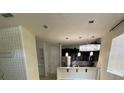 Bright kitchen with a breakfast bar, stainless steel appliances, and pendant lighting at 2546 Amati Dr, Kissimmee, FL 34741