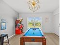 Game room featuring a pool table illuminated by a modern light, complete with view to the outside at 3137 Sun Lake Ct # B, Kissimmee, FL 34747