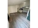 Spacious living room featuring modern flooring, fireplace, and open access to the adjacent kitchen at 4200 Thornbriar Ln # 208, Orlando, FL 32822