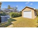 This property features a screened-in pool area, lush greenery, and a detached garage, creating a serene and private backyard at 4815 Doc Dr, St Cloud, FL 34771