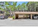 Exterior view of a condominium with covered parking and landscaping at 5311 Burning Tree Dr # D, Orlando, FL 32811