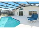 Screened-in pool with lounge chairs and outdoor dining set offers a private relaxation space at 8595 Sunrise Key Dr, Kissimmee, FL 34747