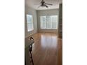Bright living room featuring wood floors and large windows that allow ample light at 8927 Legacy Ct # 302, Kissimmee, FL 34747