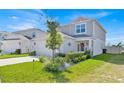 Attractive two-story home with manicured lawn, featuring well-maintained landscaping and welcoming curb appeal at 1562 Delightful Dr, Davenport, FL 33896