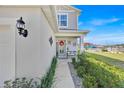 Inviting front porch with stylish bench seating and charming decor, enhancing the home's entrance at 1562 Delightful Dr, Davenport, FL 33896