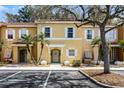 Two-story condo with a well-maintained exterior, including a front door and manicured landscaping at 1007 Park Ridge Cir, Kissimmee, FL 34746