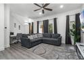 Modern living room featuring a comfortable sofa, stylish rug, and large windows for natural light at 1007 Park Ridge Cir, Kissimmee, FL 34746