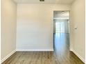 Bright living room featuring wood-look flooring and ample natural light at 1258 Royal St George Blvd, Davenport, FL 33896