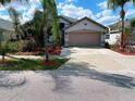 Charming single-story home with a two-car garage and beautifully landscaped front yard at 12634 Ringwood Ave, Orlando, FL 32837