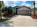 Charming single-story home with a two-car garage and beautifully landscaped front yard at 12634 Ringwood Ave, Orlando, FL 32837