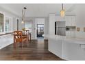 Inviting kitchen and dining area with modern appliances and stylish wood laminate flooring at 145 Kensington Park Dr, Davenport, FL 33897