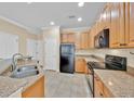 Bright kitchen featuring granite countertops, stainless steel appliances, and wood cabinetry at 1518 Orrington Payne Pl, Casselberry, FL 32707