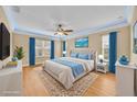 Well-lit main bedroom with a ceiling fan, stylish rug, and blue accents creating a serene and inviting atmosphere at 1518 Orrington Payne Pl, Casselberry, FL 32707