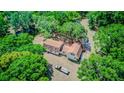 Aerial view of the home surrounded by lush green trees and a long driveway at 15345 Rockridge Rd, Polk City, FL 33868