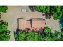 Aerial view of the home with a brown roof, mature landscaping, and a trailer parked on the property at 15345 Rockridge Rd, Polk City, FL 33868