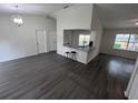 Bright and airy living room with a partial view of the kitchen and modern bar stool seating at 3216 Fieldcrest Ter, Deltona, FL 32725