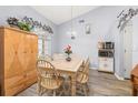 Well-lit dining room with wood floors, a tile-top table, and decorative accents at 336 California Blvd, Davenport, FL 33897