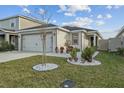 View of the exterior of the home, including the yard, driveway, and landscaping at 3930 Palazzo Pl, Winter Haven, FL 33884