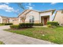 Inviting front facade showcasing lush landscaping and a covered entryway at 4911 Drawdy Ct, St Cloud, FL 34772