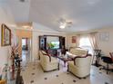 Bright and airy living room with tile flooring, a ceiling fan, and large windows at 4941 Luna Negra Dr, Orlando, FL 32811