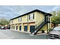 A multi-unit building featuring garages and stairs leading to upper-level entrances at 6013 Westgate Dr # 2421, Orlando, FL 32835