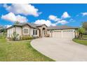 Beautiful home showcasing a long driveway and three-car garage at 6301 Oak Shore Dr, St Cloud, FL 34771