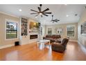 Spacious living room featuring hardwood floors, a cozy fireplace, and built-in shelving at 6301 Oak Shore Dr, St Cloud, FL 34771