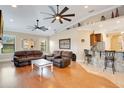 Open-concept living room showcasing hardwood floors and views of the kitchen area at 6301 Oak Shore Dr, St Cloud, FL 34771