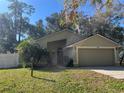 A charming one story home featuring an attached two-car garage, lush lawn and mature landscaping at 6356 Bennett Ct, St Cloud, FL 34771