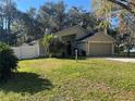 A charming one story home with an attached two-car garage, lush lawn, mature landscaping and white picket fence at 6356 Bennett Ct, St Cloud, FL 34771