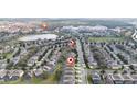 Scenic aerial of the neighborhood's houses and street layout with nearby lake and water park at 7735 Teascone Blvd, Kissimmee, FL 34747