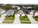 Aerial view of the house showcasing its location within a neighborhood with manicured lawns and mature trees at 7735 Teascone Blvd, Kissimmee, FL 34747