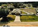 Aerial view of a home showcasing its fenced-in yard and surrounding neighborhood at 881 Hudson Valley Dr, Kissimmee, FL 34759